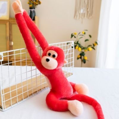 Peluche singe bras extensibles